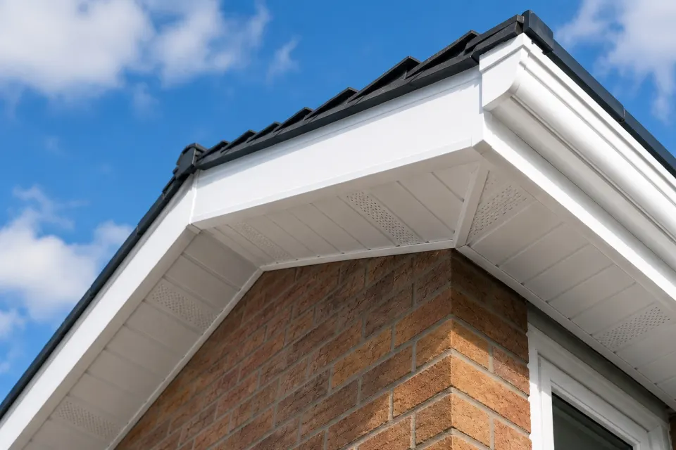 New white uPVC fascia and soffit boards fitted along a roofline above a brick corner