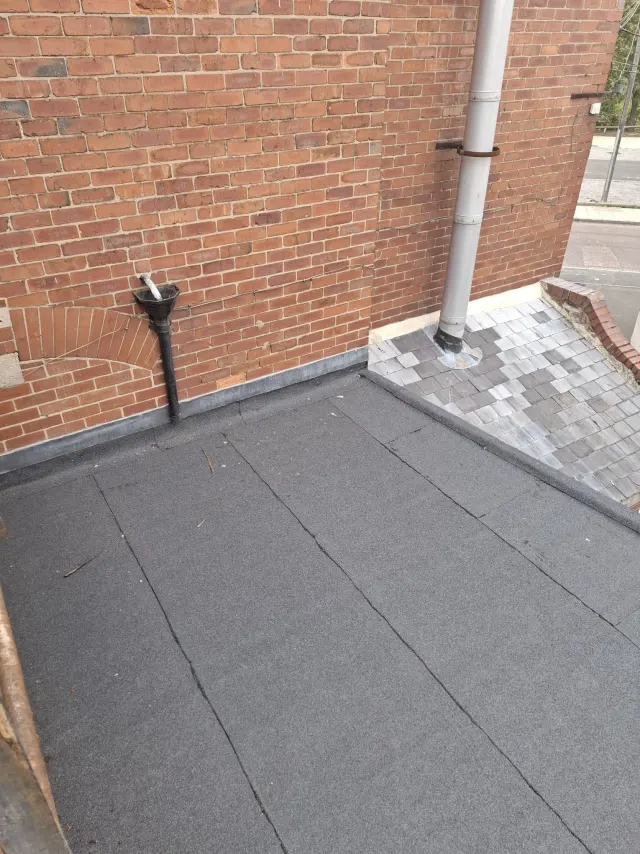Finished flat roof in Gateshead with lead flashing, downpipe hopper and new trim detailing